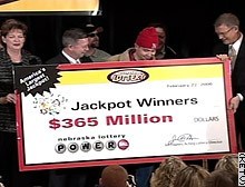 Lottery officials present the new millionaires with an oversize check for $365 million Wednesday.