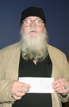 This photo released by the Massachusetts State Lottery shows Timothy B. Elliott in the Lottery's Braintree, Mass., office Monday, Nov. 26, 2007, after he won a $1 million prize playing the Lottery's $800,000,000 Spectacular. He's in trouble because he's also a convicted bank robber who isn't supposed to be gambling. The state probation commissioner's office has scheduled a hearing for December 7 to determine whether Elliott, 55, violated his probation when he bought the $10 ticket.